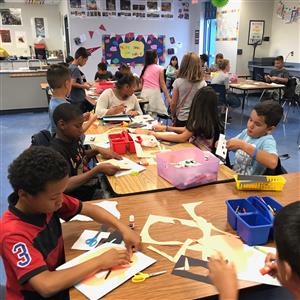 Students create pumpkin art. 
