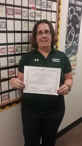 Teacher posing with her spotlight teacher  certificate. 